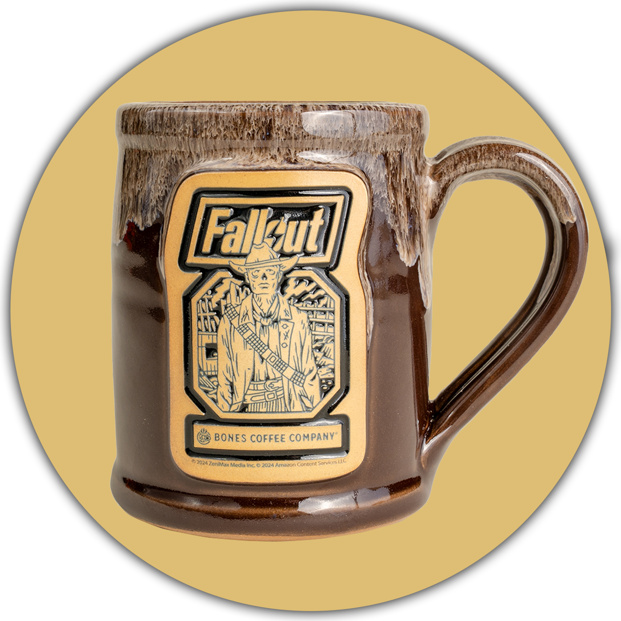 The front of the Bones Coffee Company Ghoul hand thrown mug with the Wasteland Crunch art on the golden medallion. It is inspired by Zenimax and Amazon’s Fallout show. The mug is chocolate colored with a sand white glaze on top. A light brown circle is behind it.