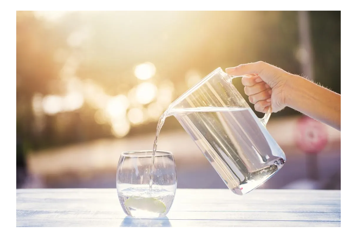 pouring water from a pitcher into a glass