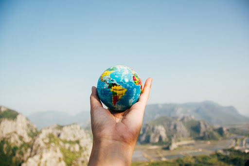 hand holding round planet earth globe