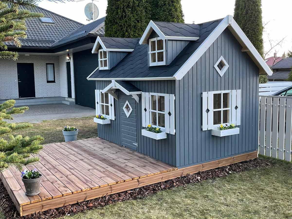 Wooden Gray Playhouse with black roof and white trims and window shutters and flower boxes by WholeWoodPlayhouses