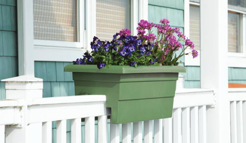 Sage green railing planter with flowers on a front porch railing