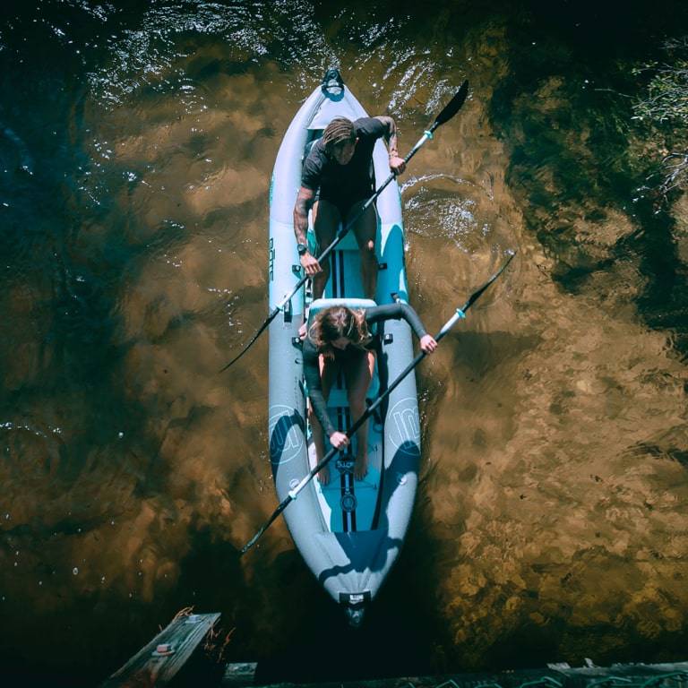 Overhead view of a man and woman paddling the Zeppelin Aero together