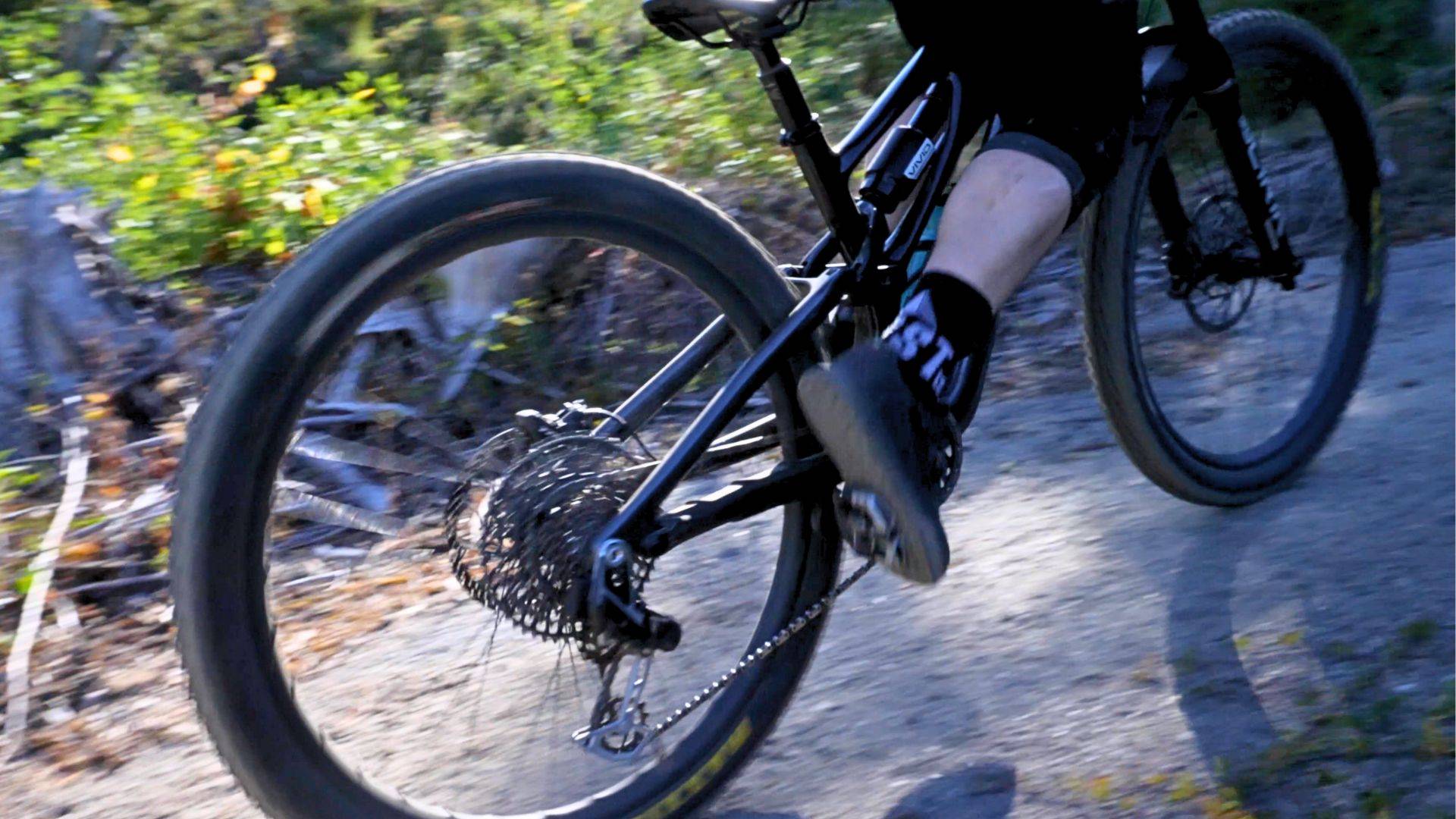 pedaling a stumpjumper evo with rockshox vivid ultimate mountain bike shock climbing over rock