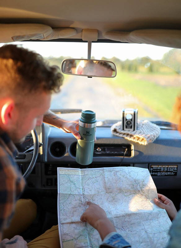 Couple looking at map sitting in the car