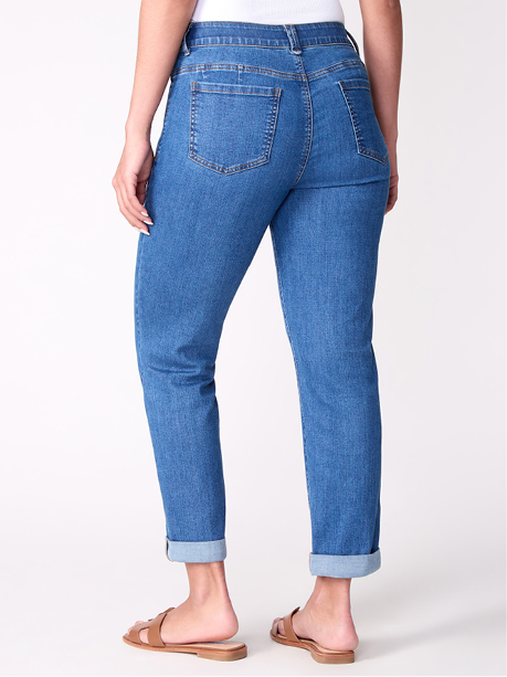 Woman wearing light blue jeans and brown sandals.