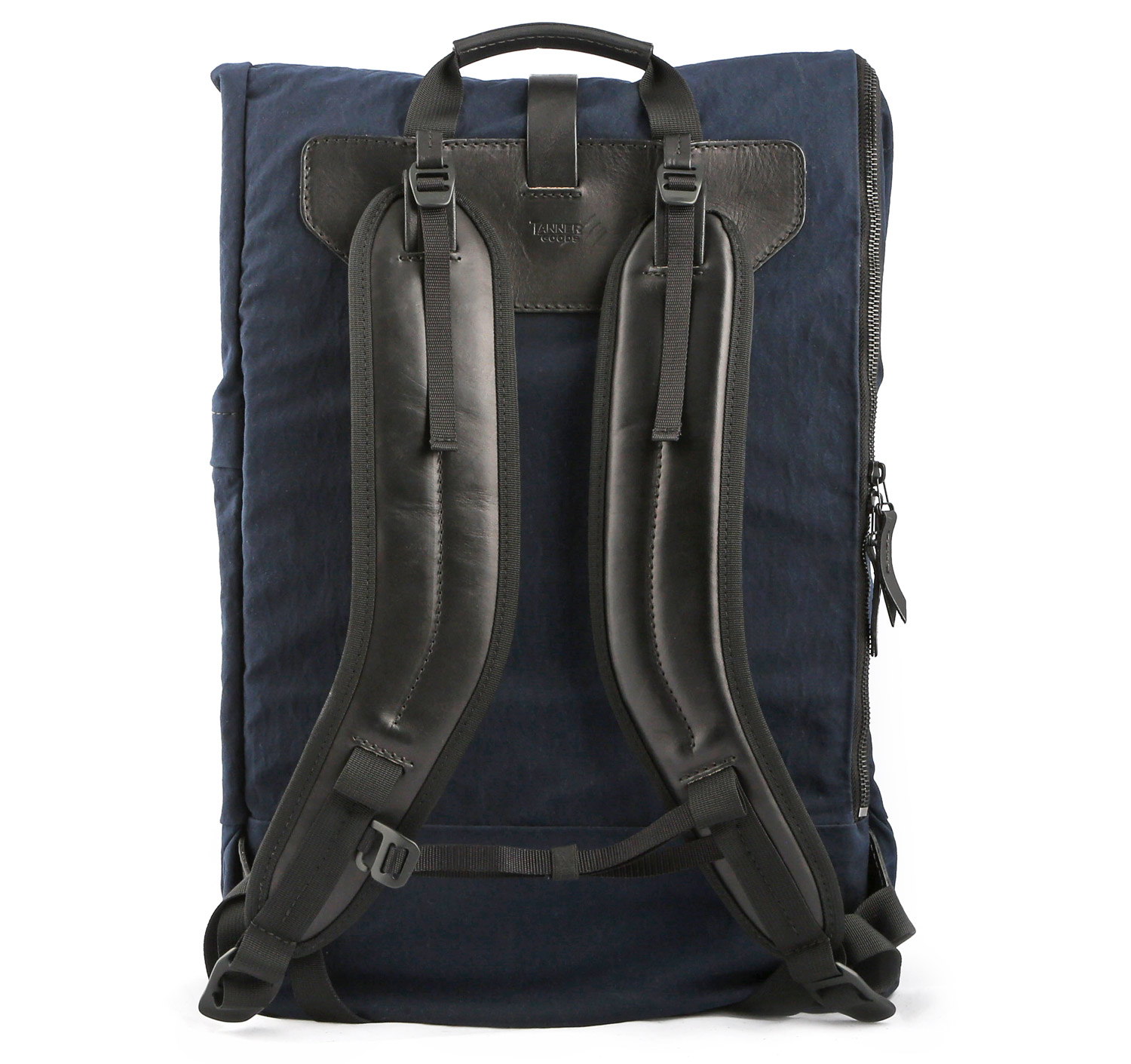 The backside of a navy blue backpack with black straps and accents.