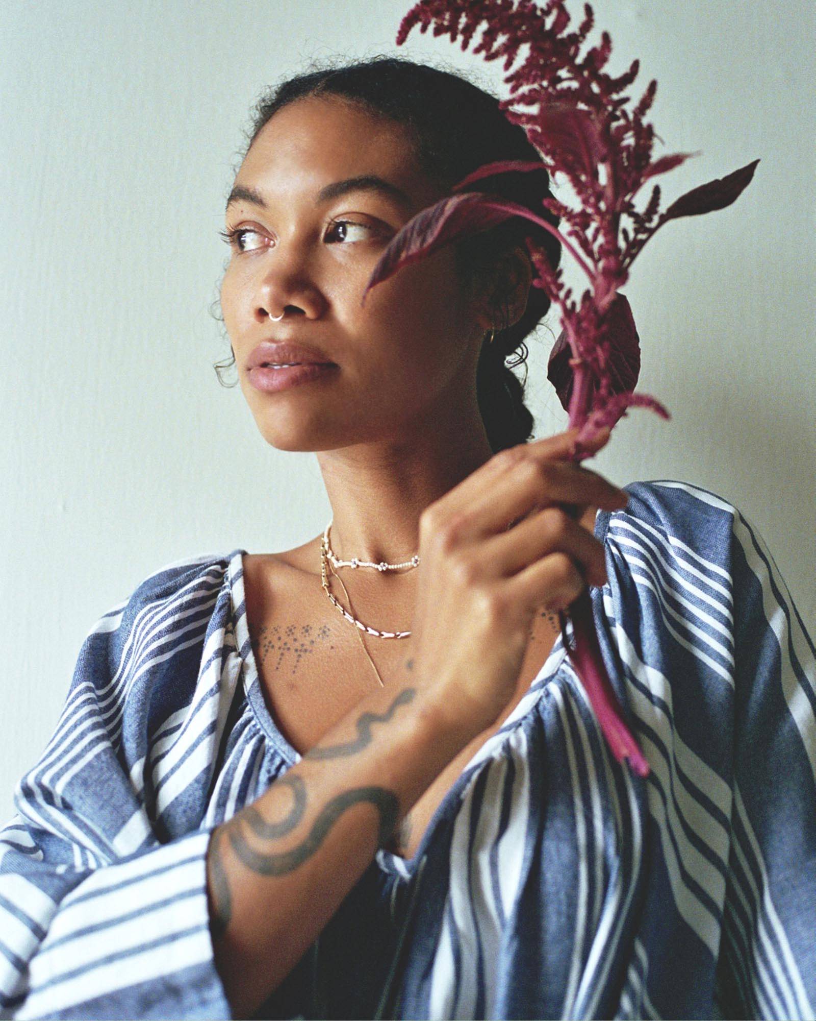 Image of model wearing blue and white dress by Mara Hoffman.