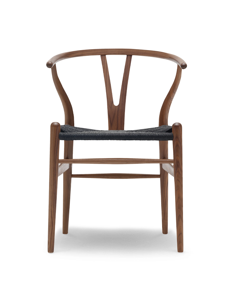 Wooden chair CH24 Dining Chair with a curved back and black seat, viewed from the back.