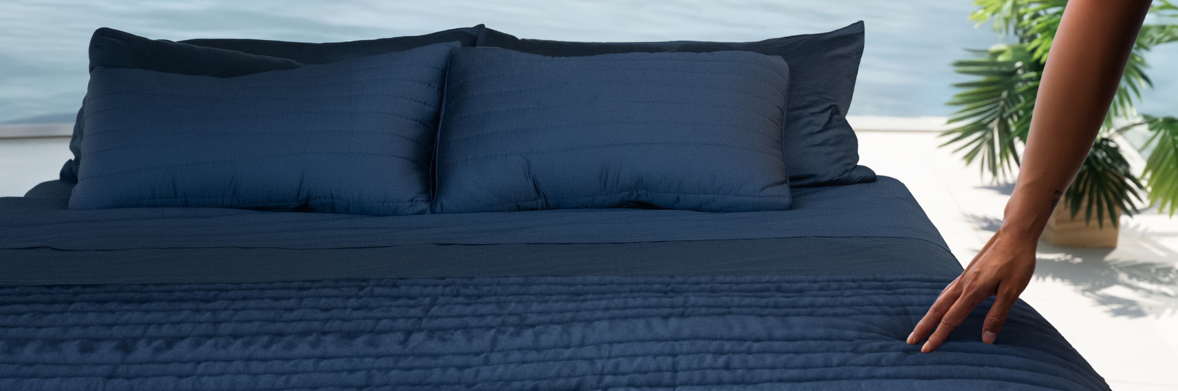 a woman on a bed with cariloha bedding