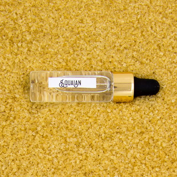 Squalane oil against a sugar background