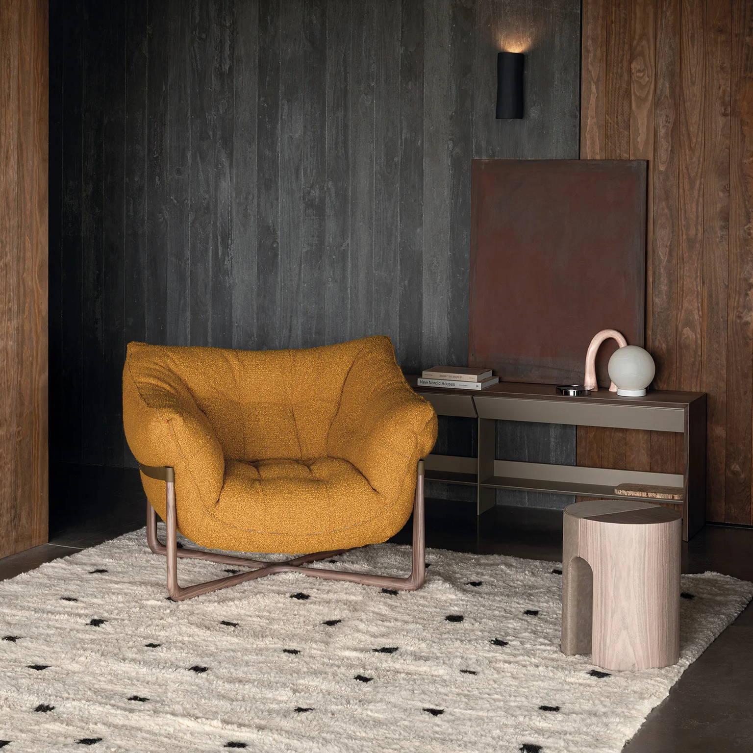 Cozy room with a yellow chair, wooden walls, and a patterned rug.
