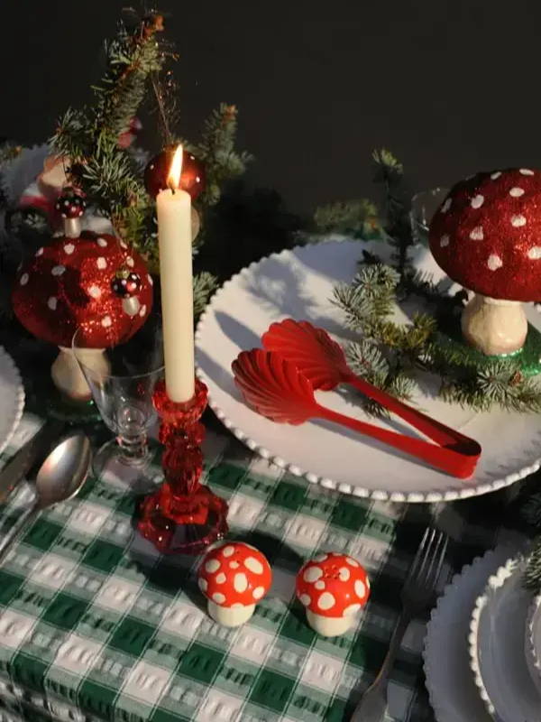 A close up of a green and red laid christmas table.