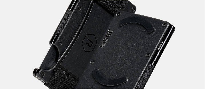 Black device with curved edges, possibly a phone or tablet holder.