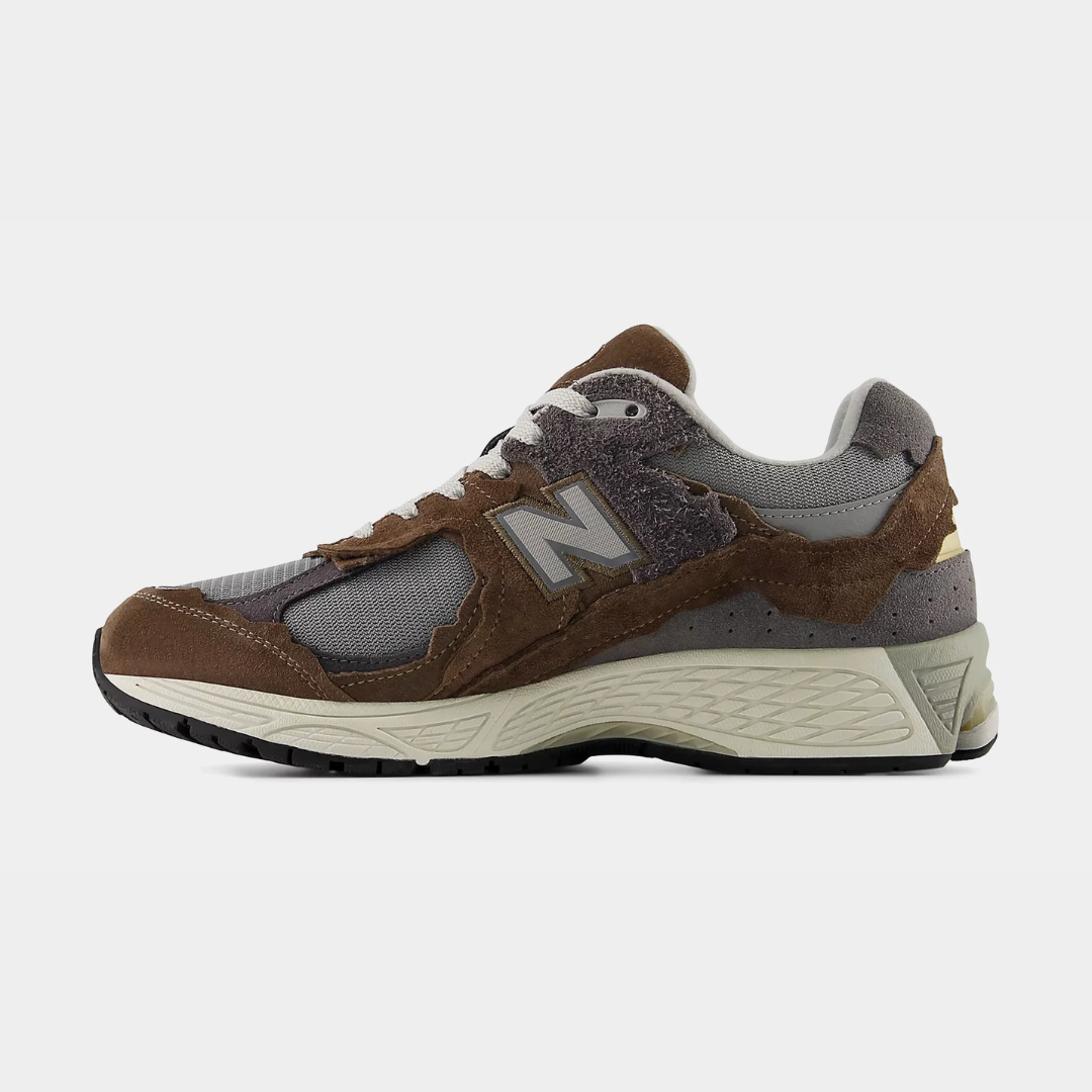 Brown and gray New Balance sneaker on a white background.