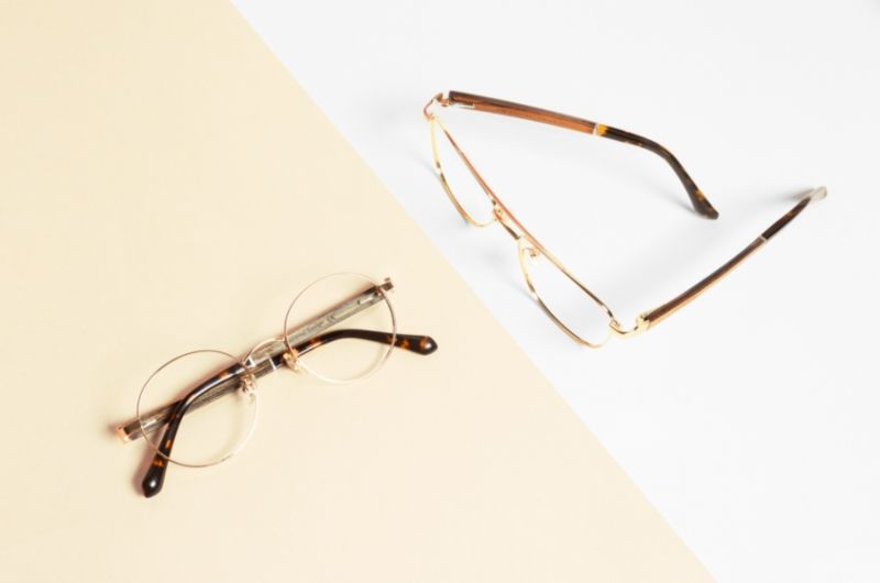 flat lay image of Kraywoods glasses for oval face shape on a white and pink color block background