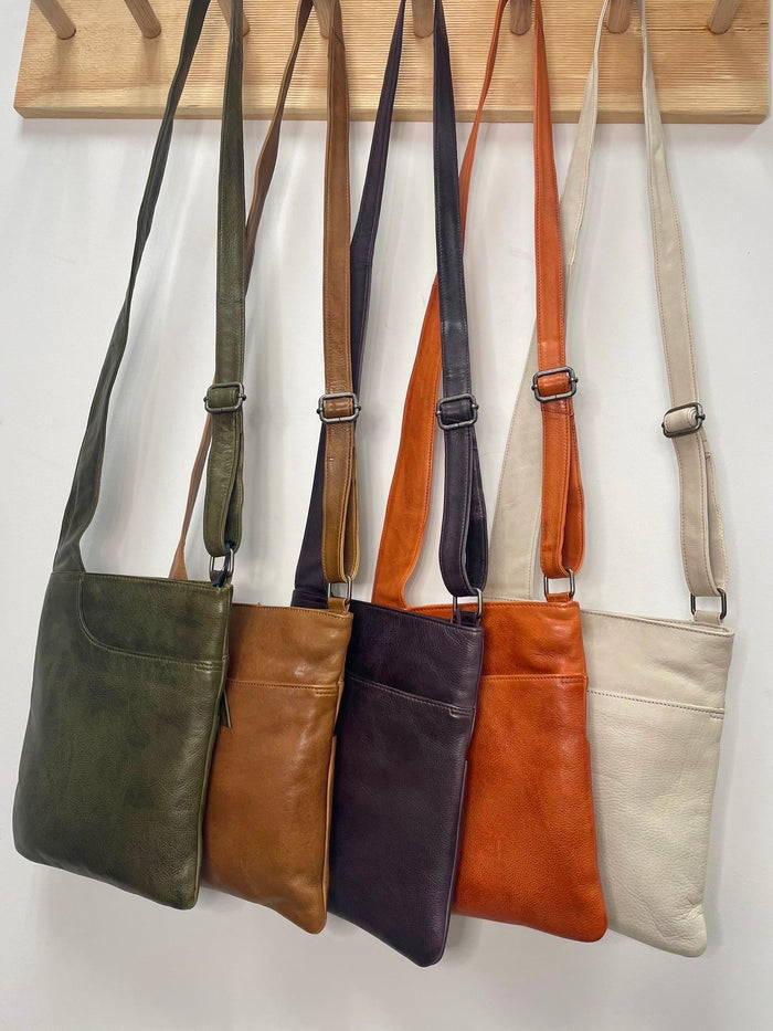 leather shoulder bags hanging on hooks