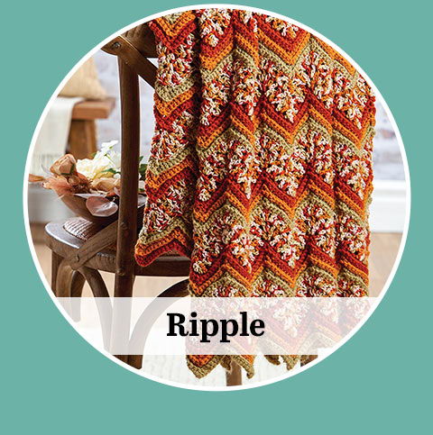 Colorful patterned blanket draped over a chair with the word 