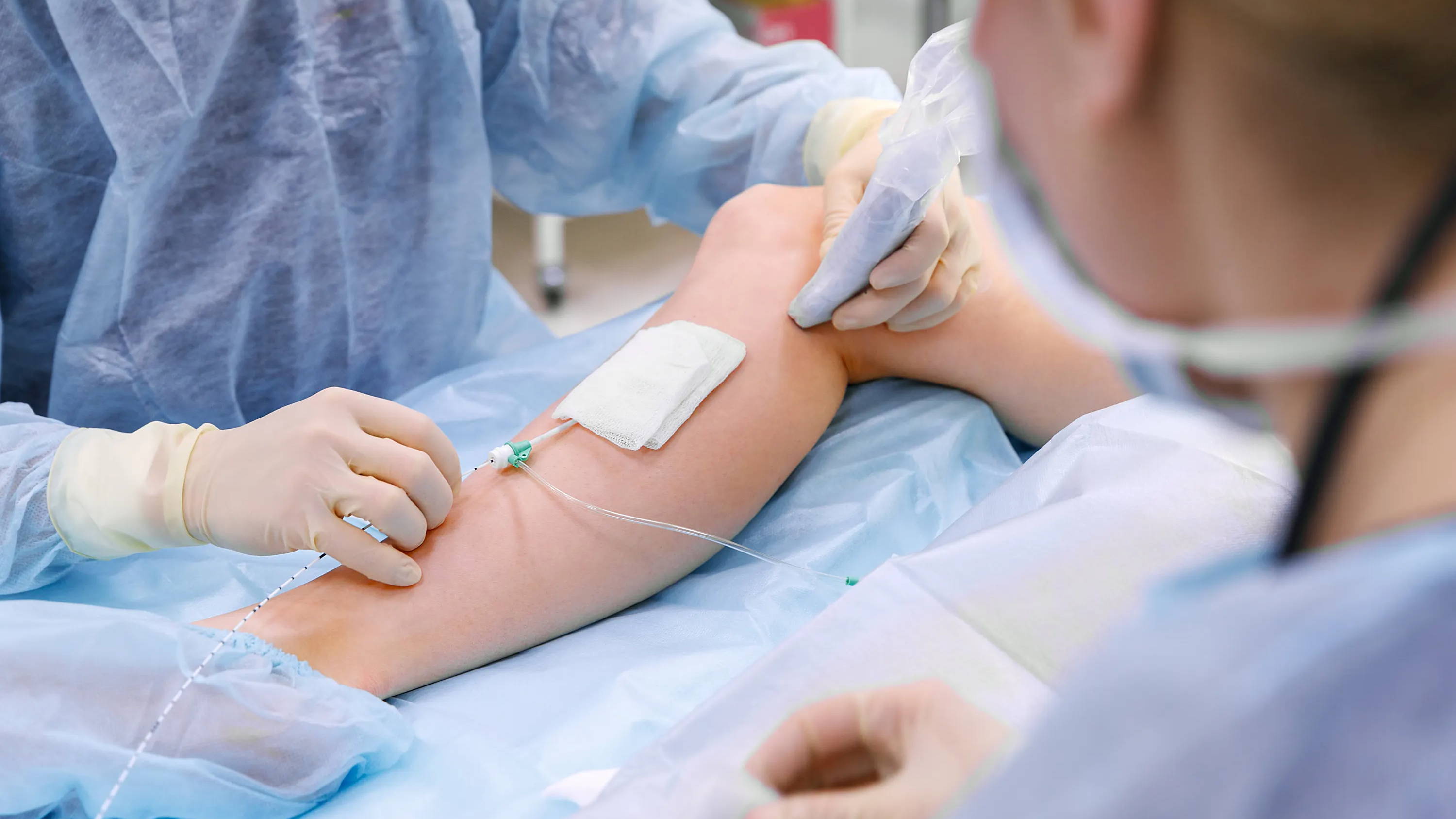 Doctors performing vein surgery on a woman