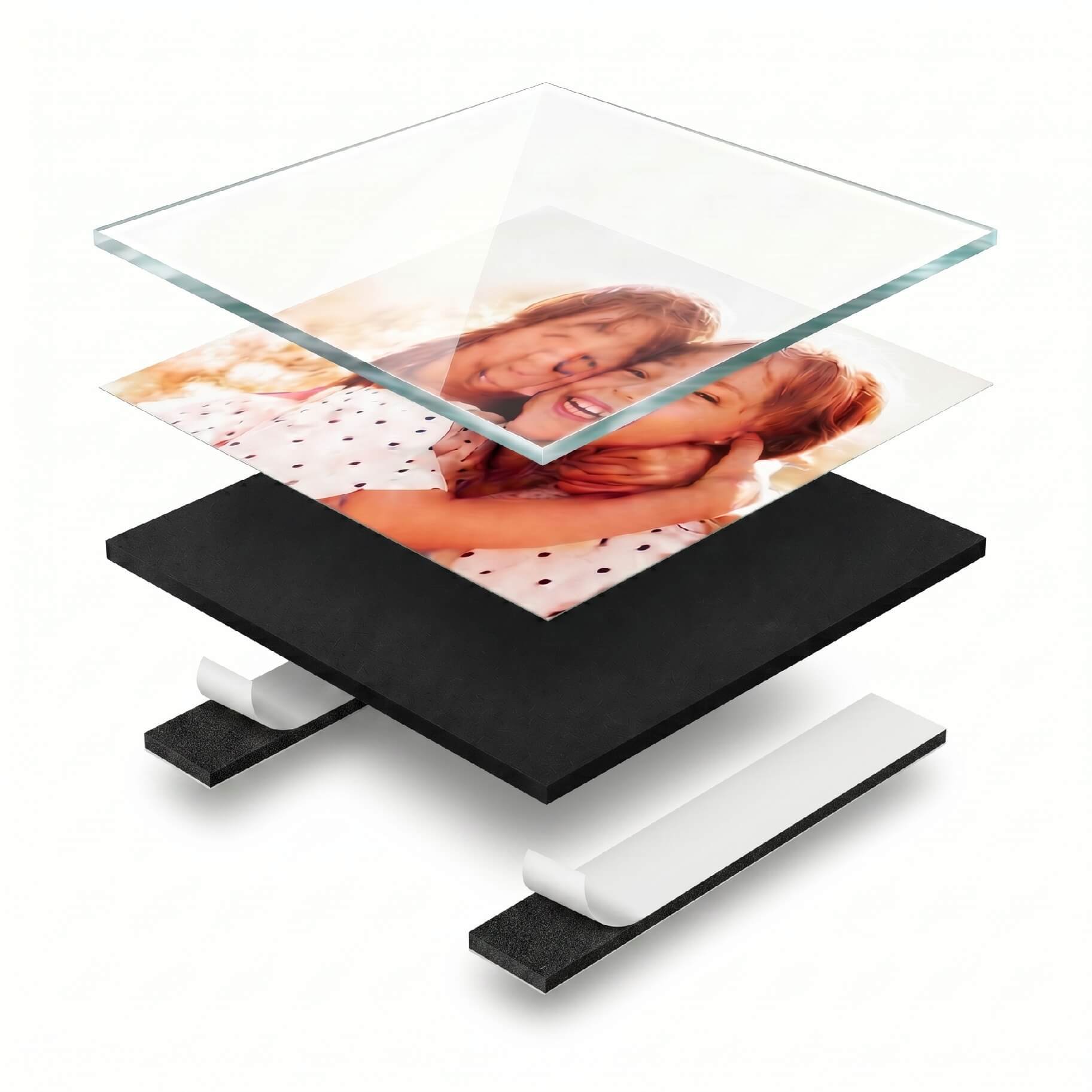 A layered photo display with glass and black base showcasing a family picture.