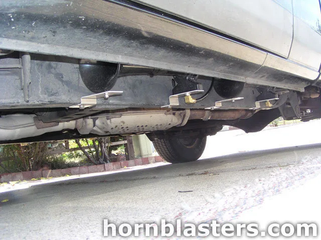 Rear three-quarter Leigh's Nissan Frontier tailgate taillights bed stance with train horn build context photo 3