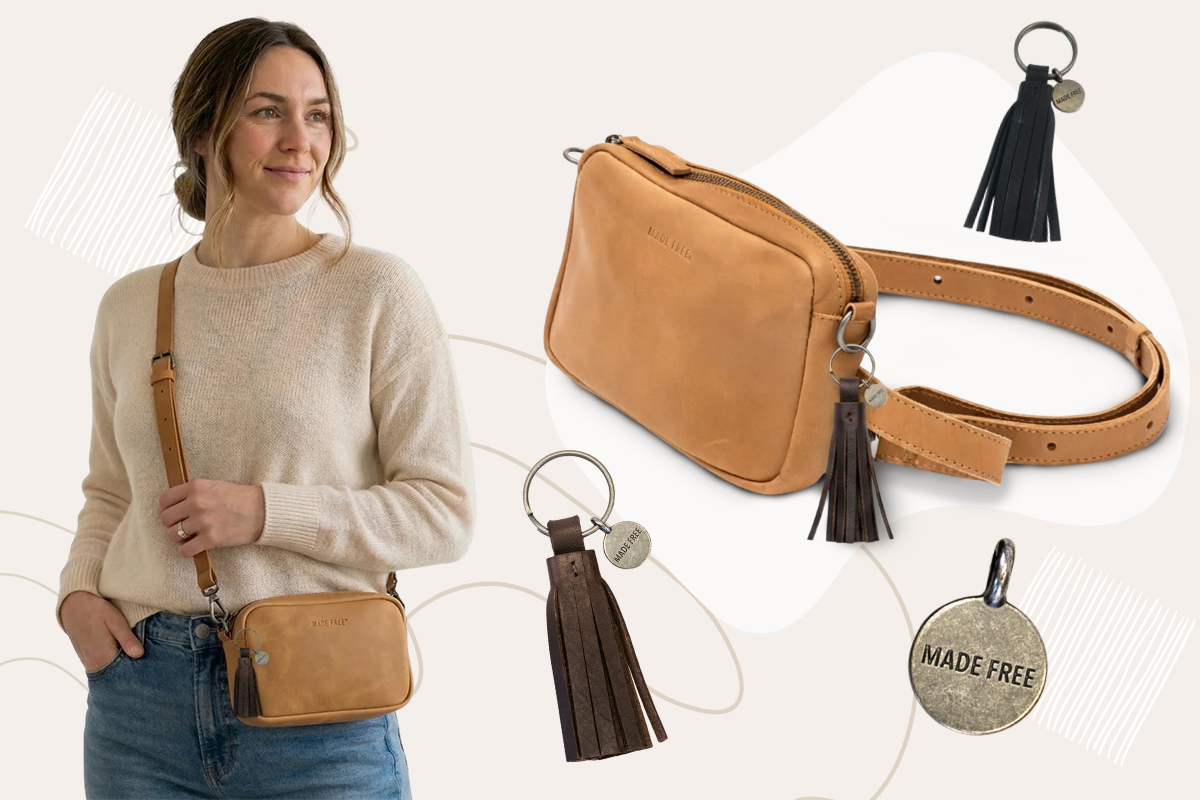 Woman holding a brown bag with tassels, featuring keychains and light background.