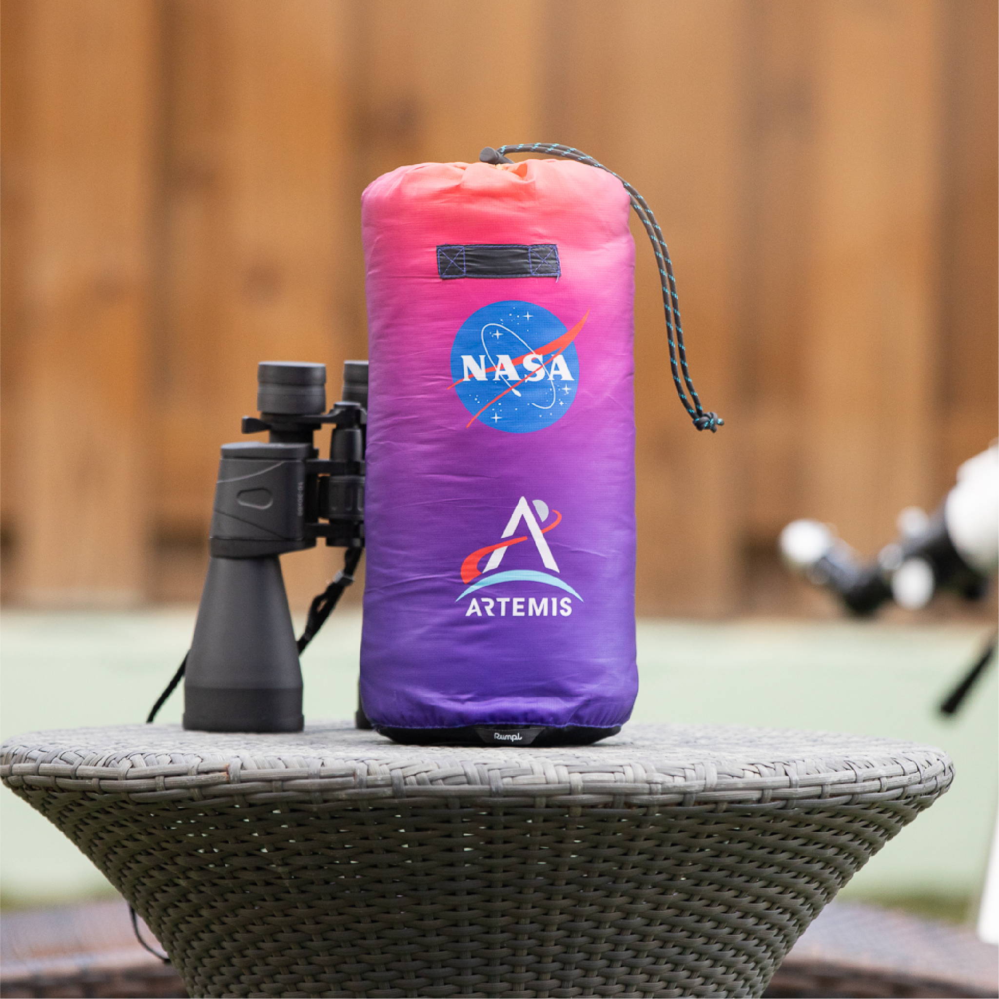 NASA Artemis Rumpl blanket sitting by binoculars