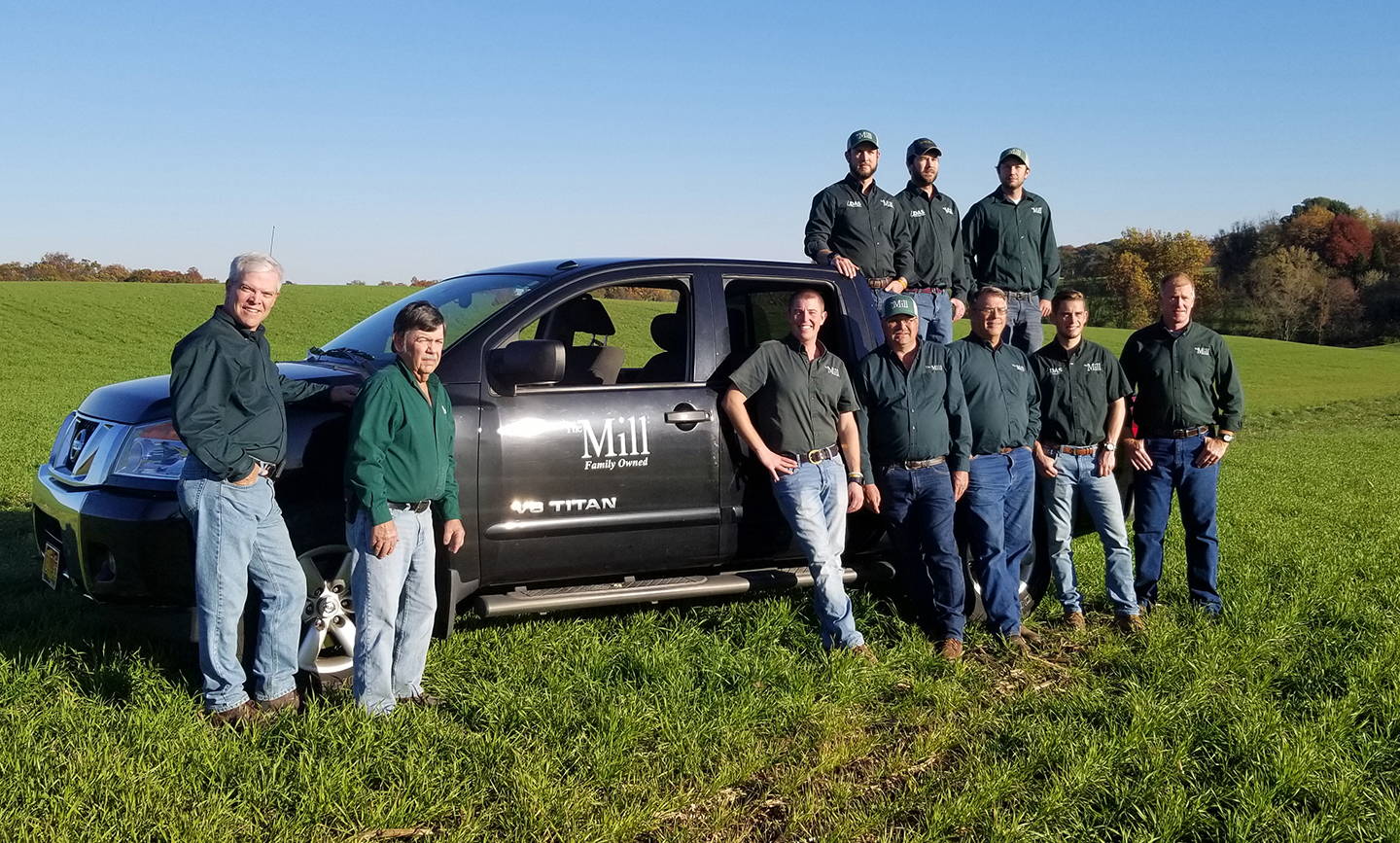 The Mill agronomists next to a pickup