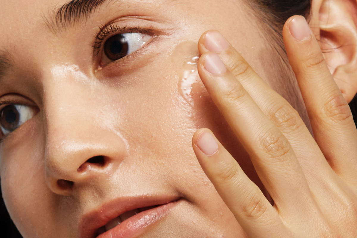 girl applying serum by depology Antioxidant serum for aging spots and spf protection 