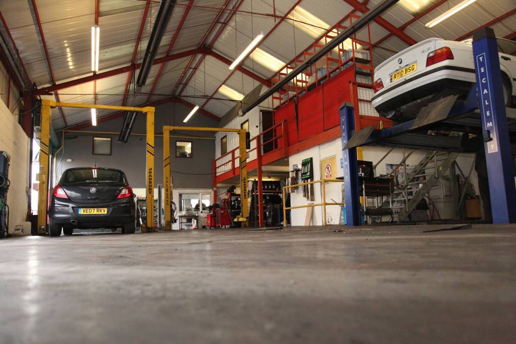 Inside car garage with cars parked 