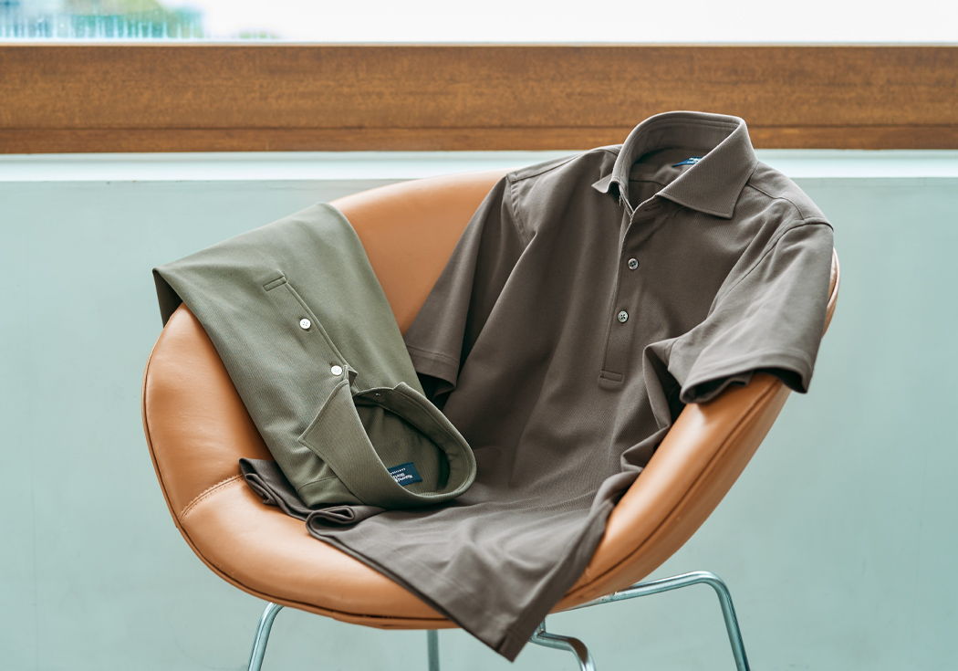 A brown shirt and pants draped over a modern chair.