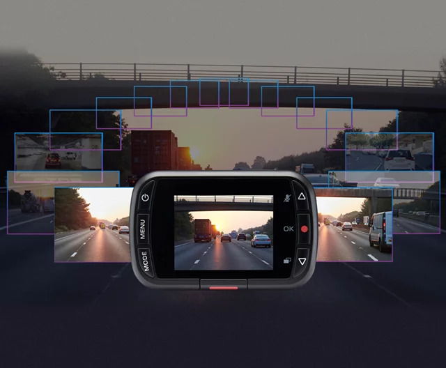 A smartphone displays highway images with an overpass in the background.
