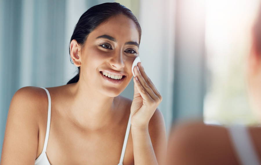 woman removing makeup with coconut oil