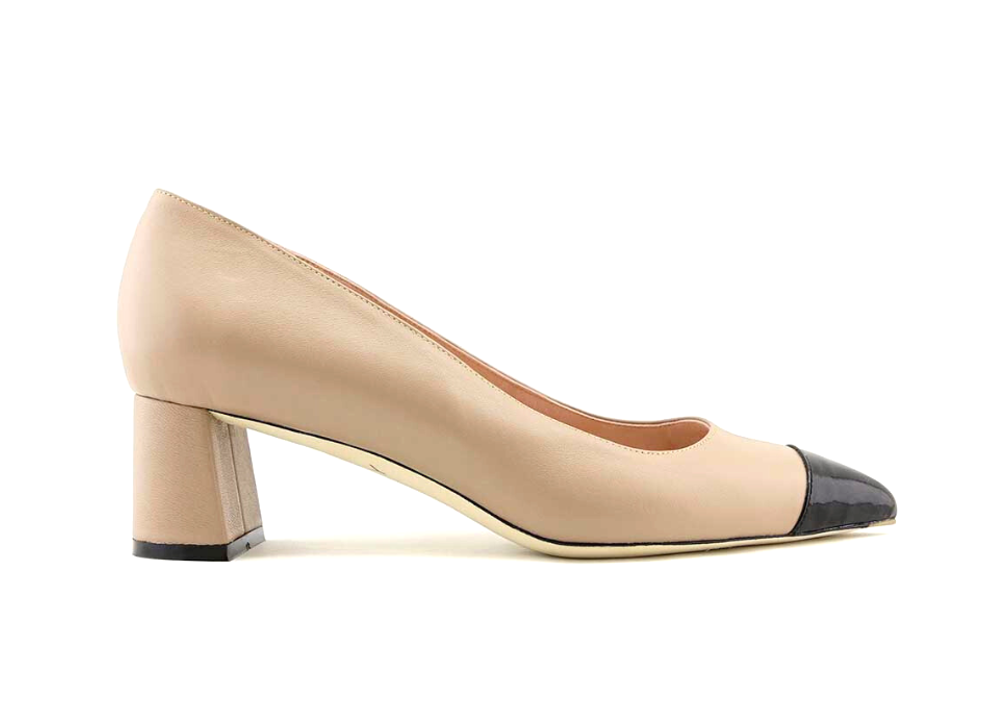 Beige high heel shoe with a black toe cap.