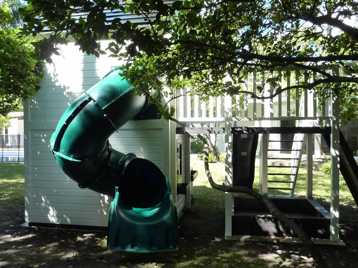 Outdoor Custom Playhouse with spiral slide by WholeWoodPlayhouses