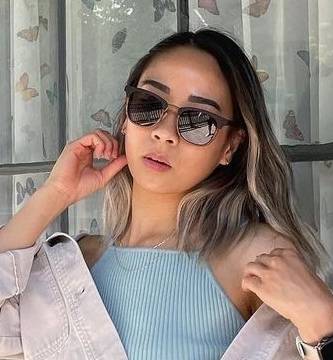 Woman wearing Casper, Clubmaster Wood Two Tone Sunglasses with Grey Polarized Lens with a blue shirt and a light coloured jean jacket