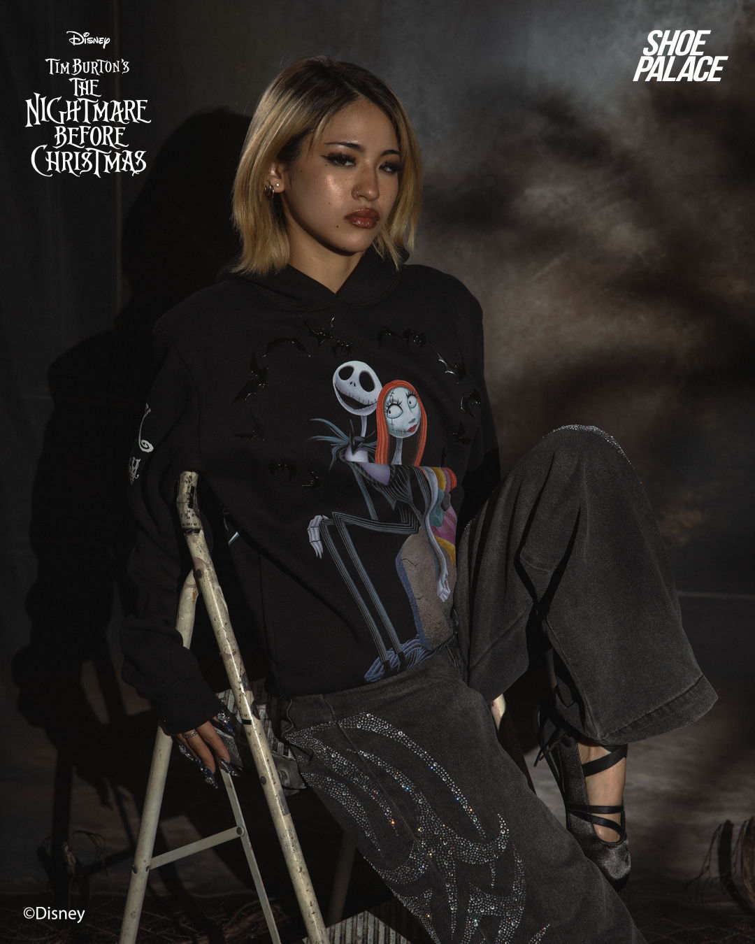 Person wearing a hoodie with Jack and Sally from The Nightmare Before Christmas.