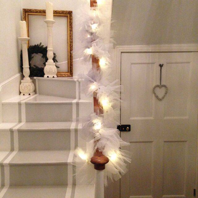 Light up garland wrapped around a bannister.
