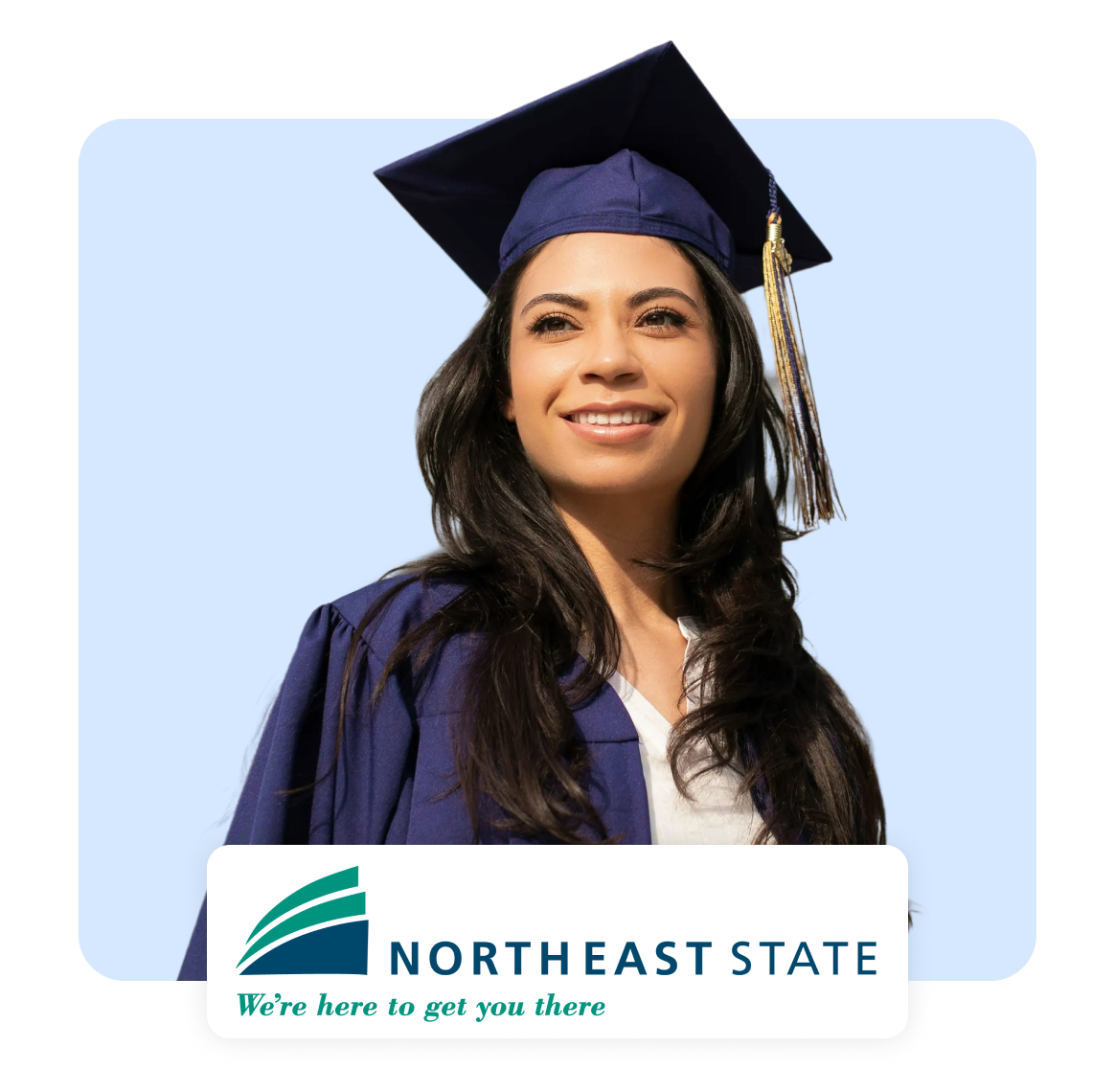 Smiling graduate wearing cap and gown in front of a blue background.