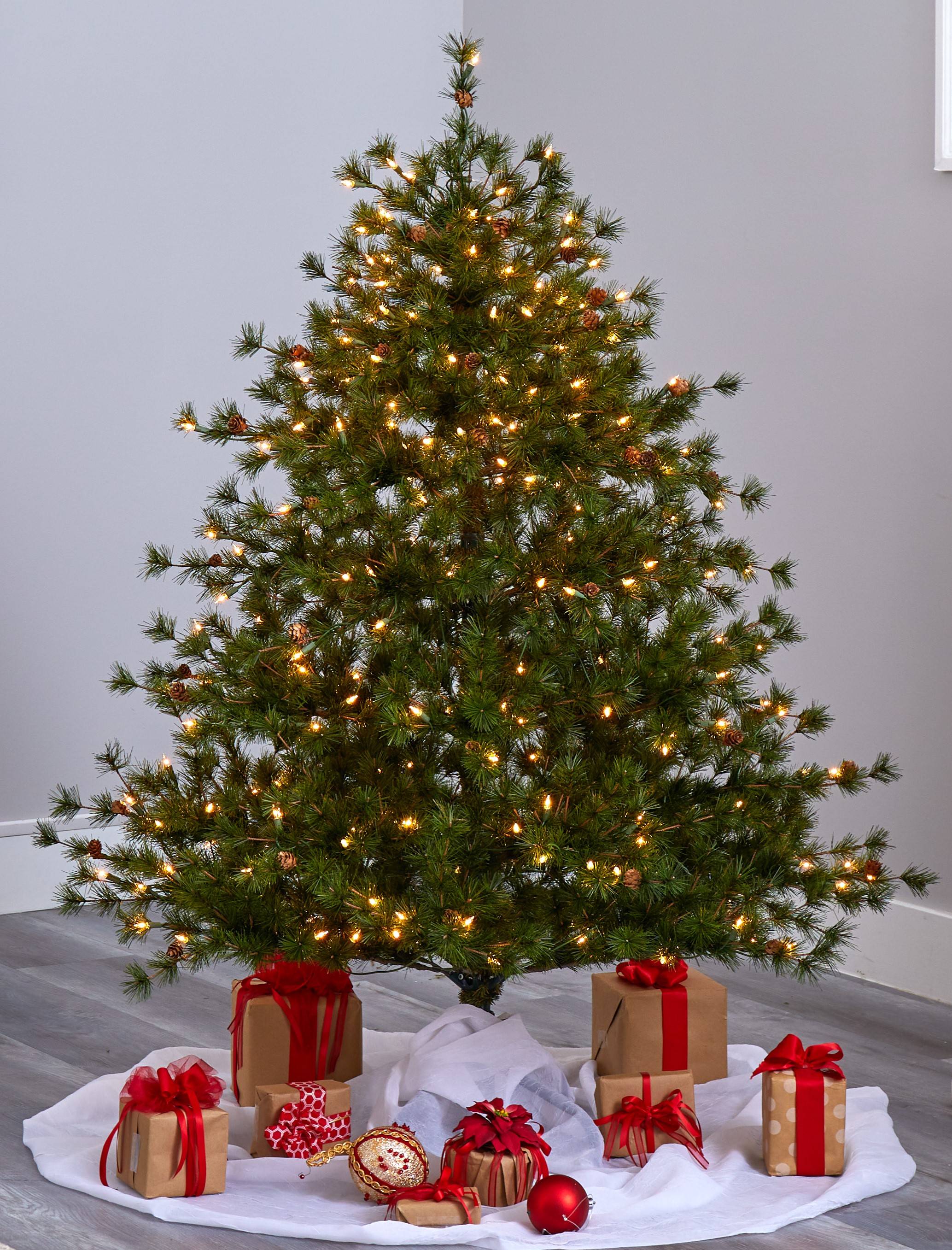 A Christmas tree with Christmas and holiday gifts under the tree