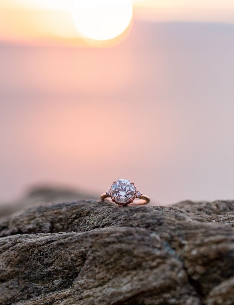ken & dana lebow ring on a rock by the beach at sunset