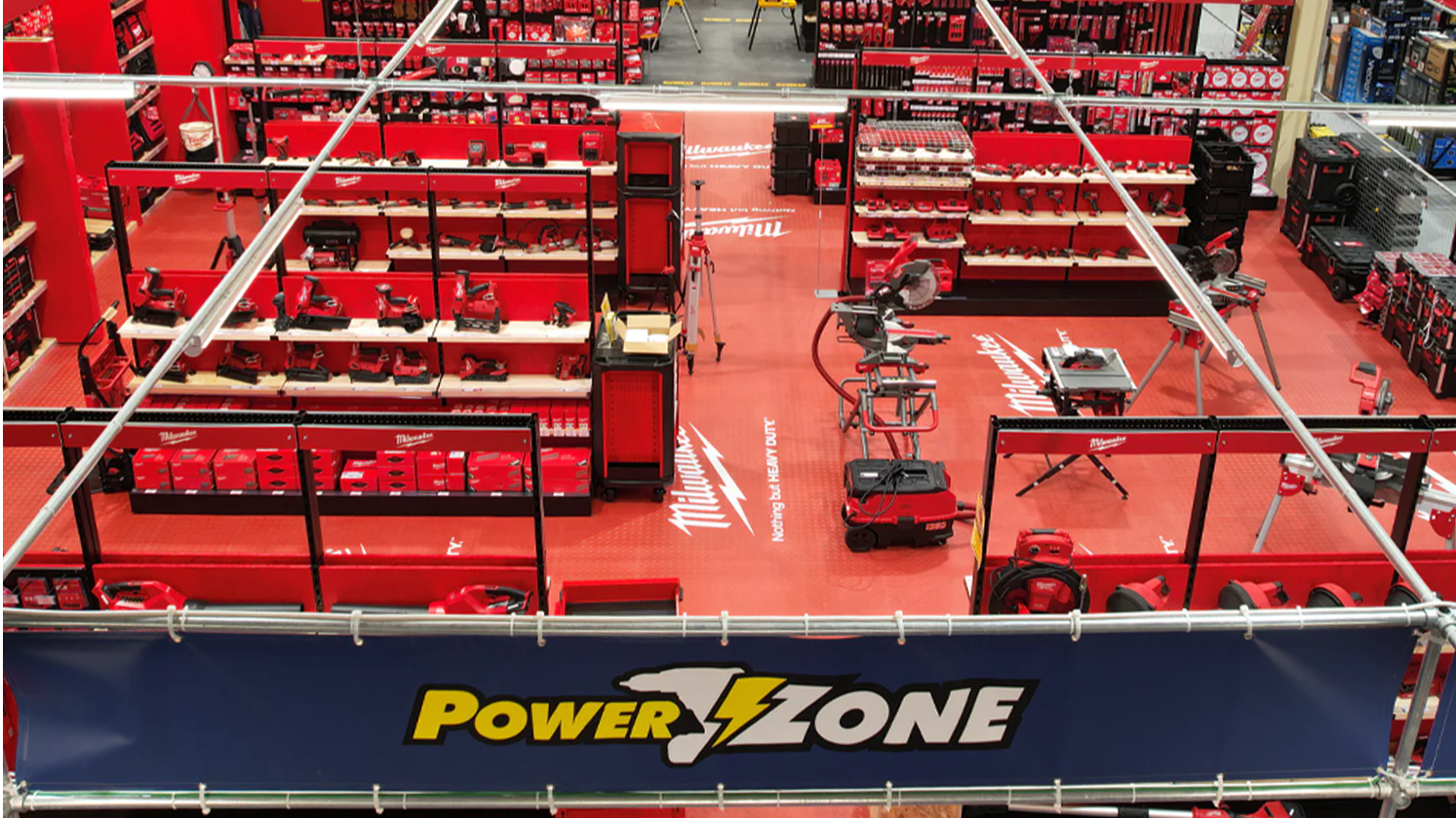 Aerial view of a vibrant retail space with red displays and tools.