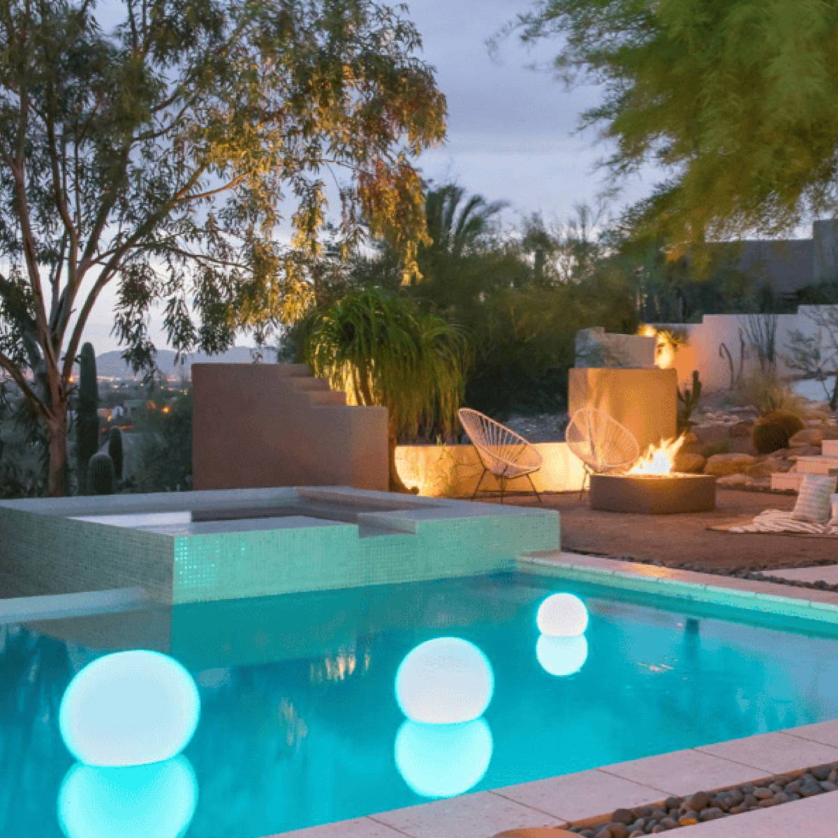 Glowing lights floating in a pool captivate while a fire burns in the background