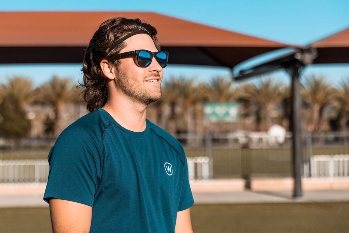 Man wearing tortoiseshell sunglasses with blue lenses