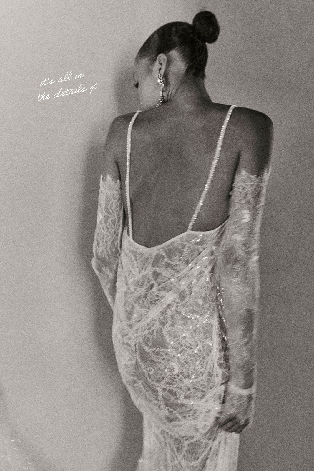 A person wearing a backless lace dress, viewed from behind.