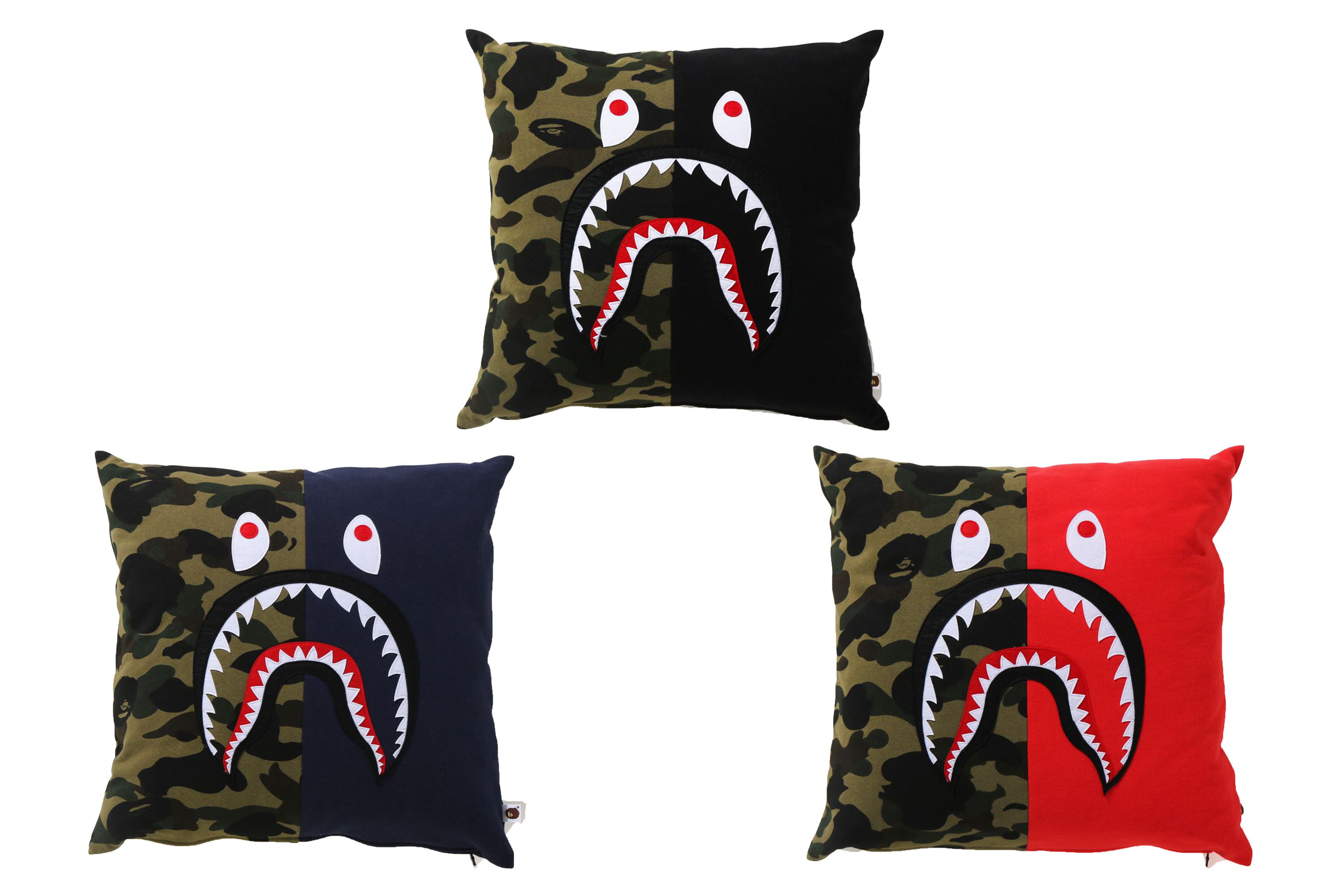 Three decorative pillows featuring a shark mouth design in various colors.