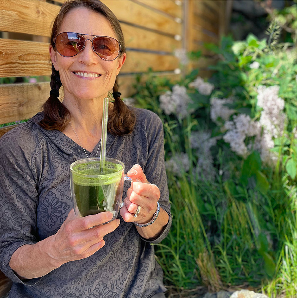 Old woman holding in a cup daily greens