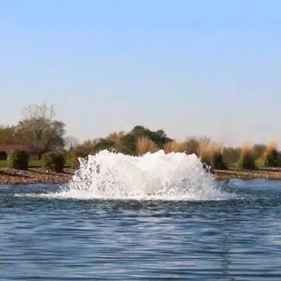Floating pond aerator churns water