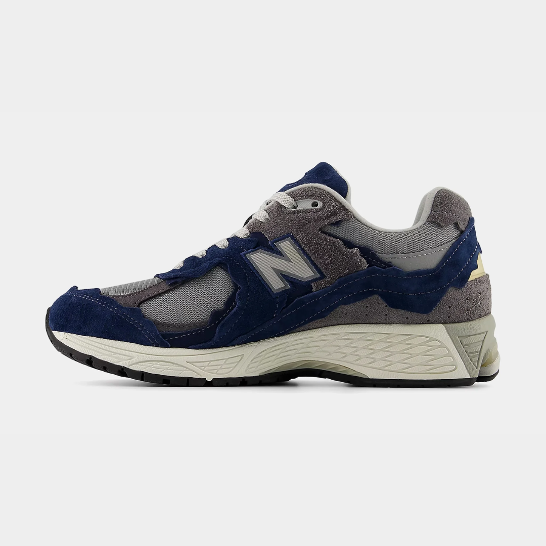 Blue and gray New Balance sneaker on a plain background.