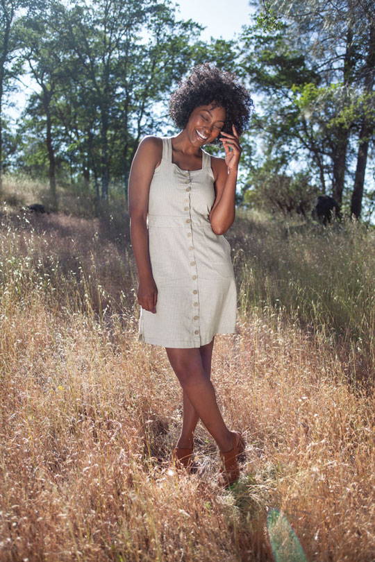 Woman standing in field wearing Breeze dress.