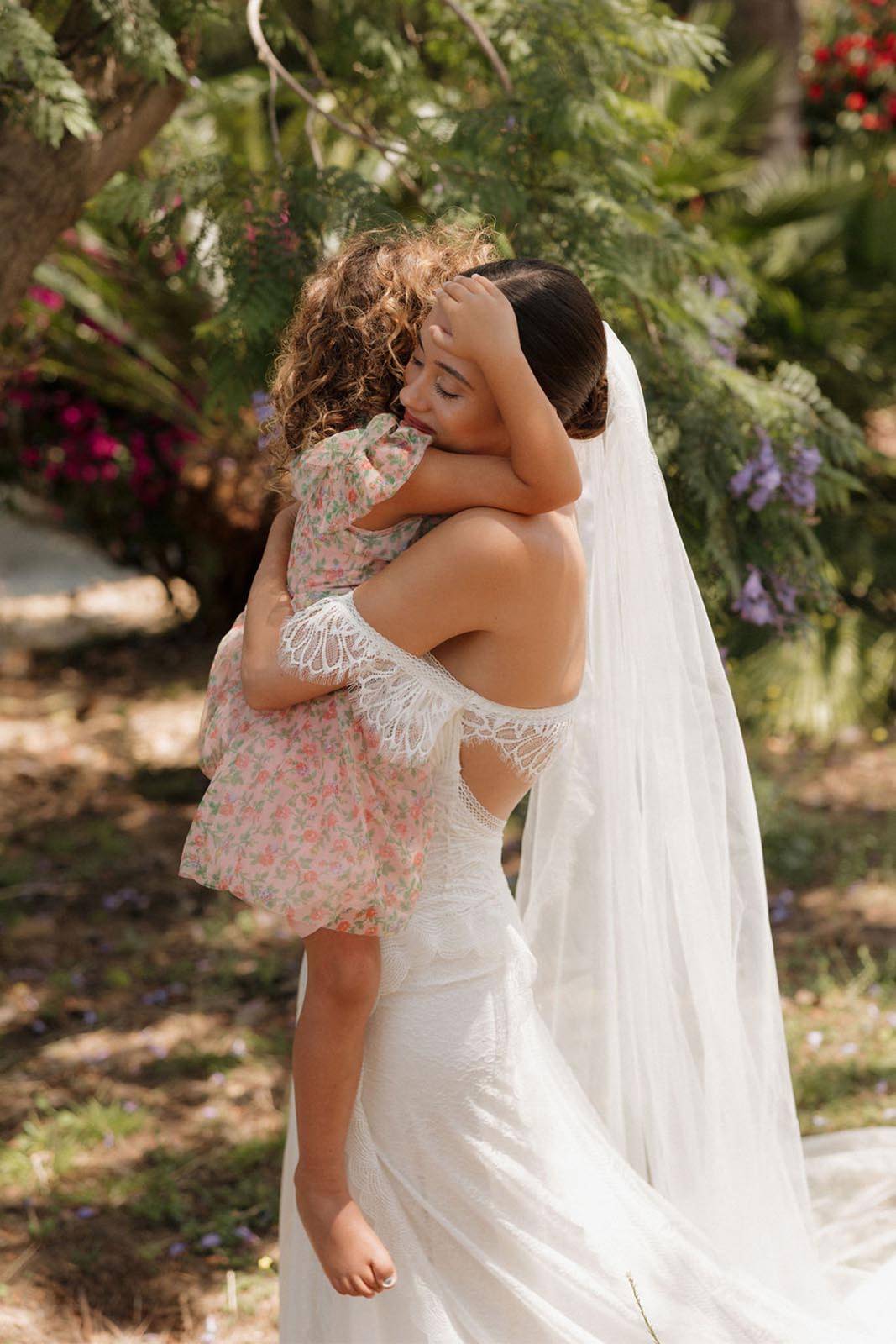 Bride, holding a cute little girl in her arms